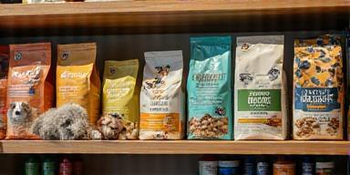 Selection of premium dog and cat food, treats, and eco-friendly pet supplies on display